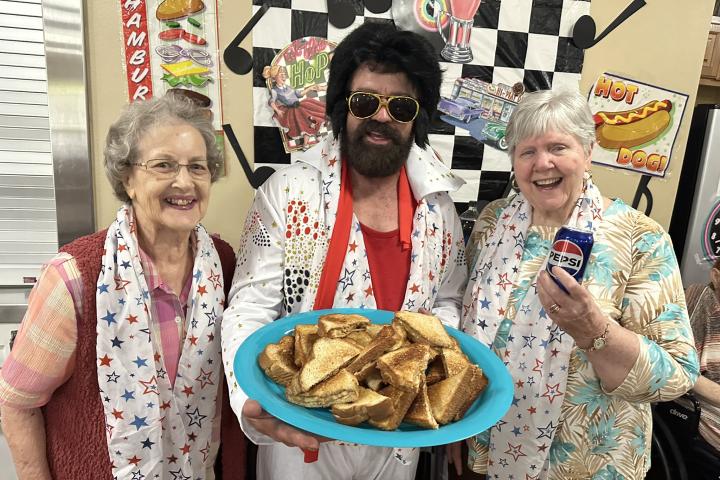 Elvis enjoys Pepsi and peanut butter & banana sandwiches with Wanda & Beverly.
